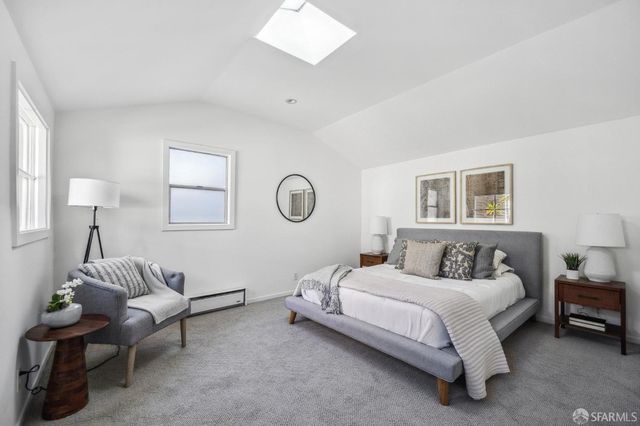 a bedroom with bed and a window