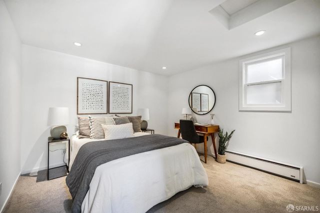 a bed room with a bed chair and a window