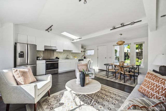 a living room with furniture and kitchen view