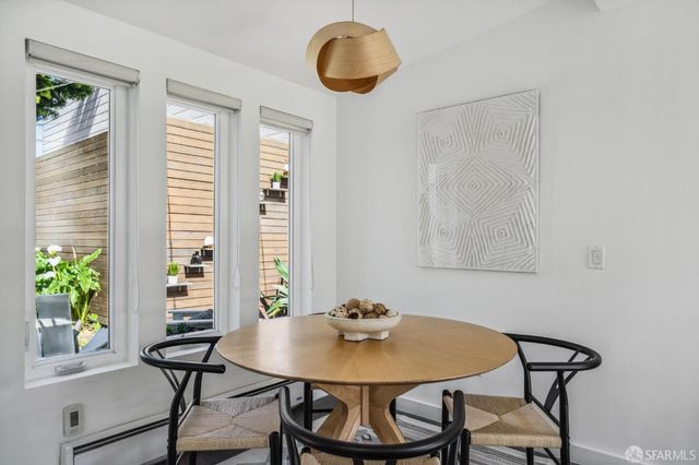 a view of a dining room with furniture and window