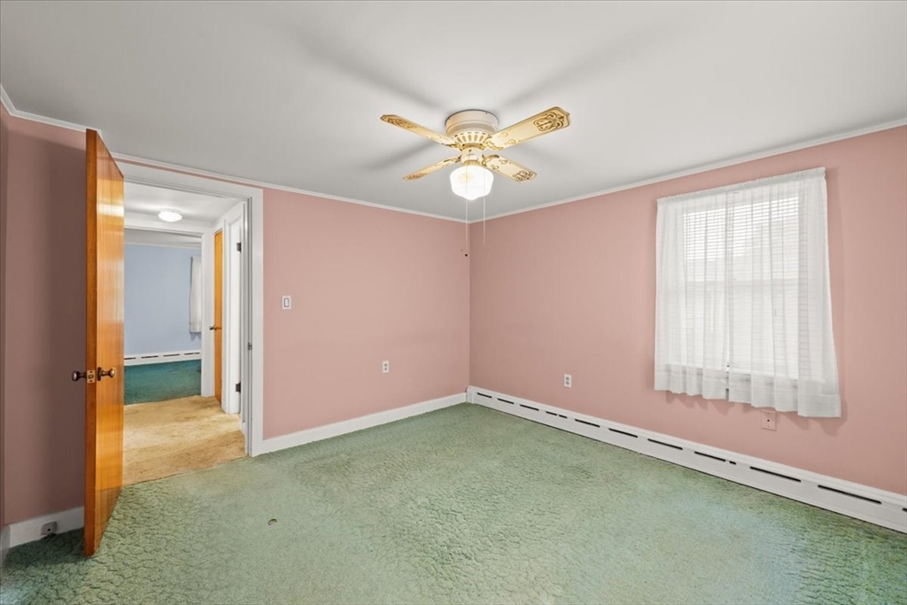 435 Sandwich Road Falmouth, MA 02536 - Photo 27 of 29 an empty room with a ceiling fan and a window