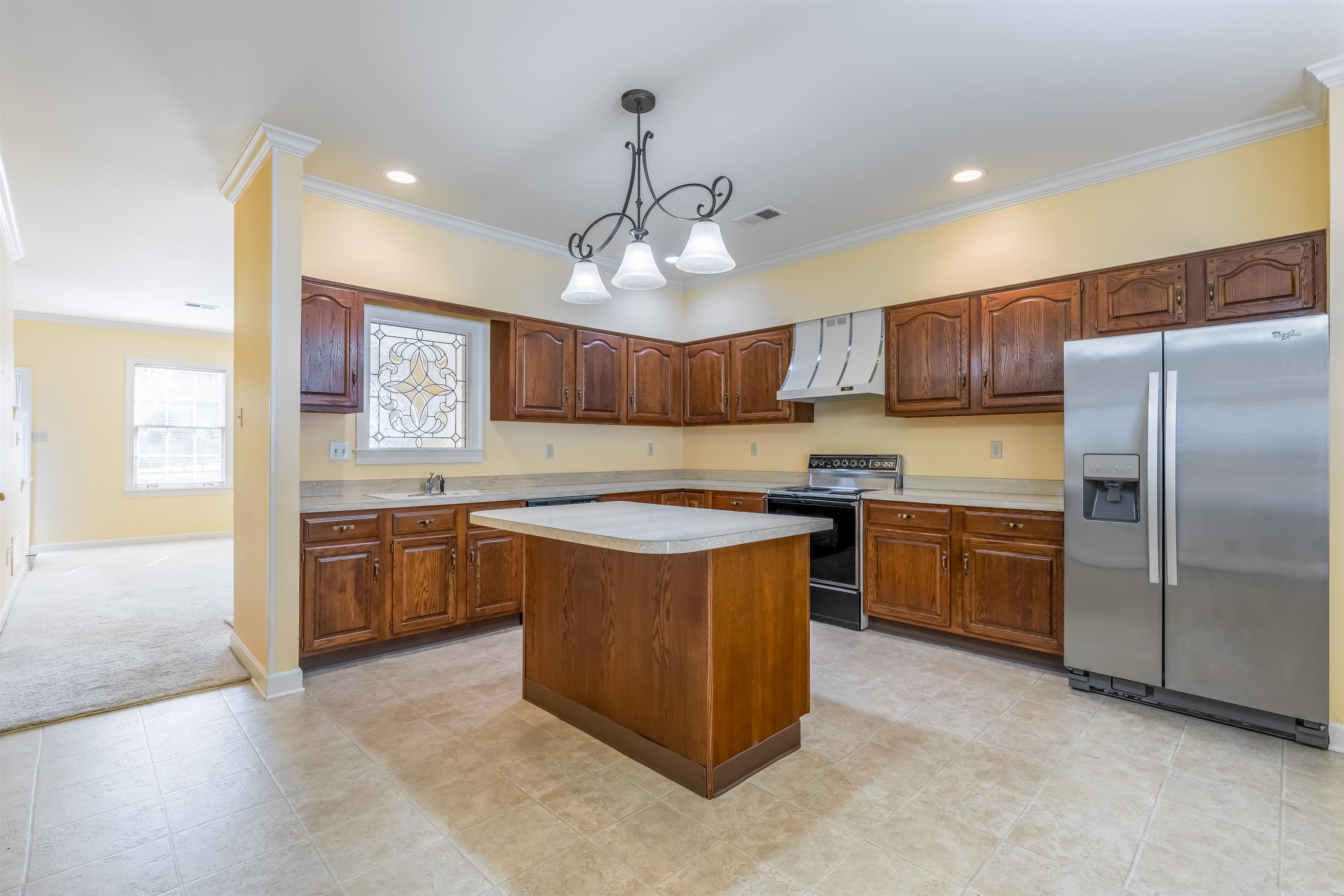 1657 Kimbrough Road, Unit 1657 Germantown, TN 38138 - Photo 11 of 25 a kitchen with stainless steel appliances granite countertop a sink a stove a refrigerator cabinets and living room view