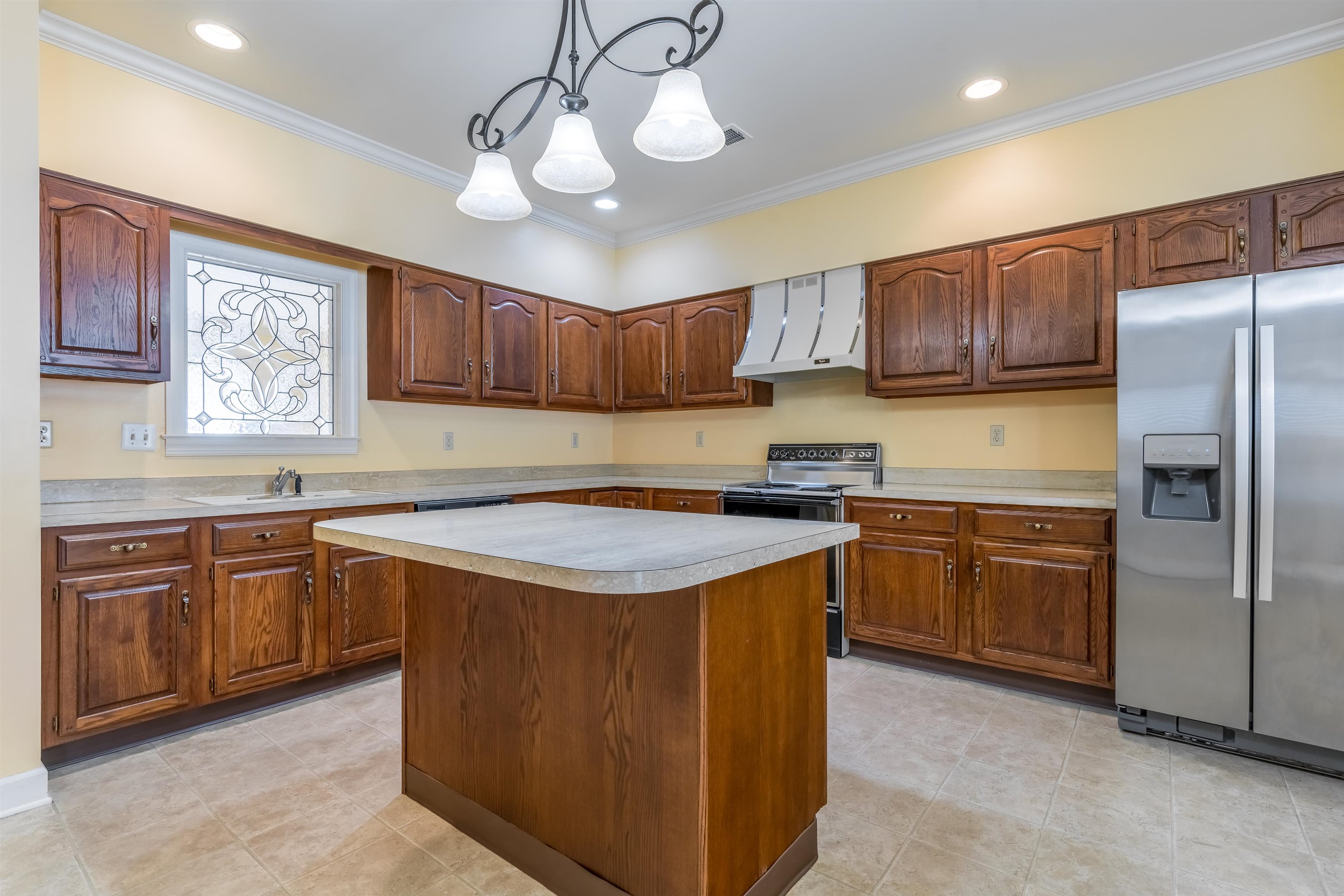 1657 Kimbrough Road, Unit 1657 Germantown, TN 38138 - Photo 12 of 25 a kitchen with stainless steel appliances granite countertop a sink a stove a refrigerator cabinets and a chairs