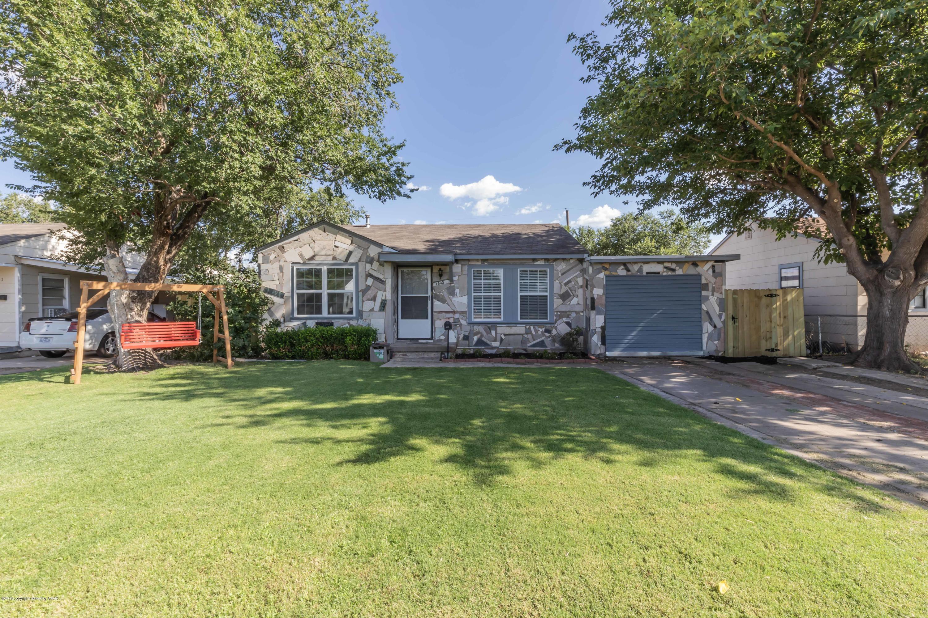 1603 Southwest 48th Avenue Amarillo, TX 79110 - Photo 1 of 31 a front view of a house with garden