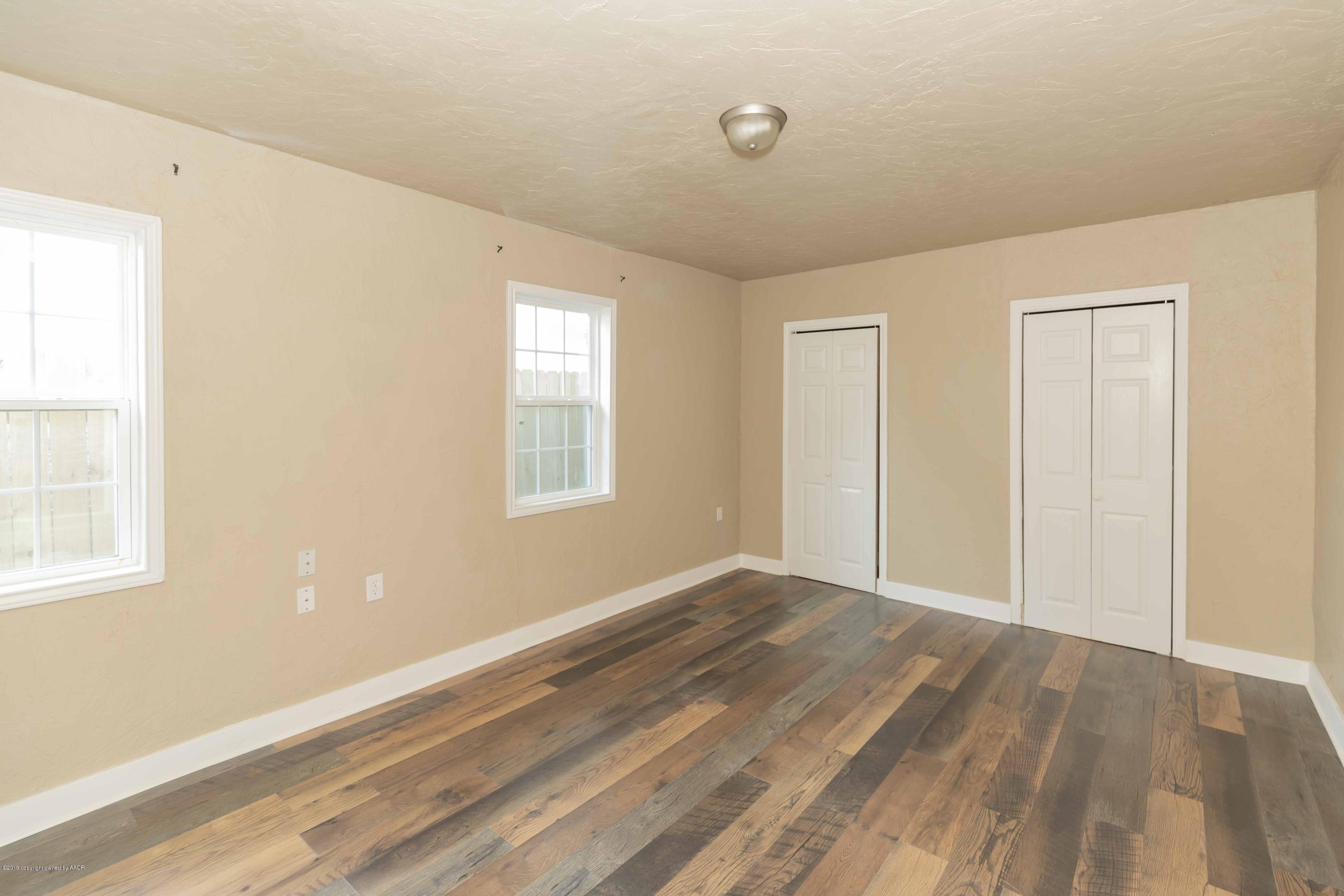 1603 Southwest 48th Avenue Amarillo, TX 79110 - Photo 22 of 31 a view of an empty room with wooden floor and a window