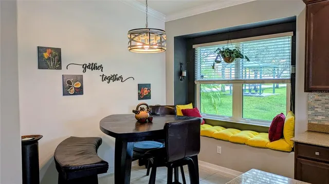 a dining room with furniture and a window