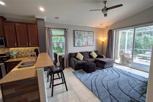 a living room with furniture fireplace and a large window