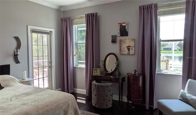 a bedroom with a bed and windows