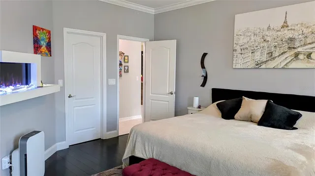 a bedroom with a bed and a painting on the wall