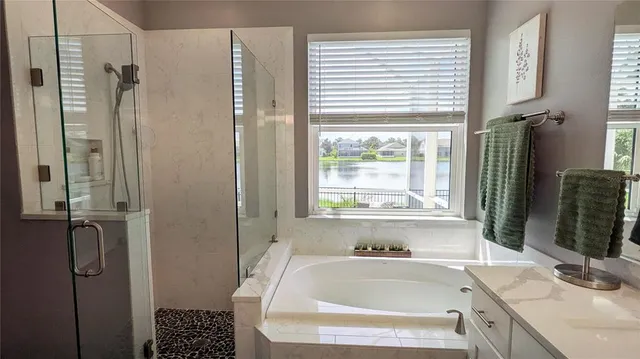 a bathroom with a tub sink and window