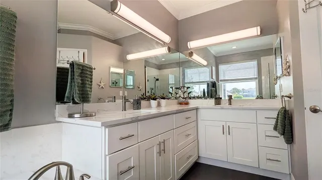 a bathroom with a sink a large mirror and vanity