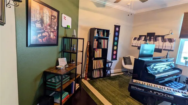 a living room with furniture a bookshelf and a window
