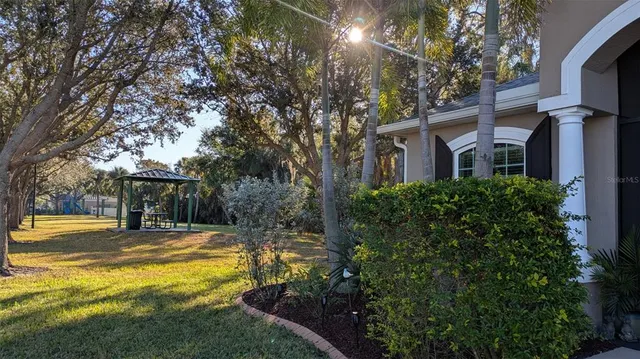 a house view with swimming pool in front of it