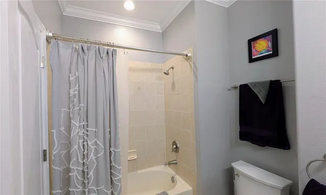 a bathroom with a toilet a sink and a shower