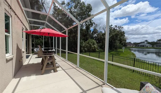 a view of a patio with chairs next to a yard