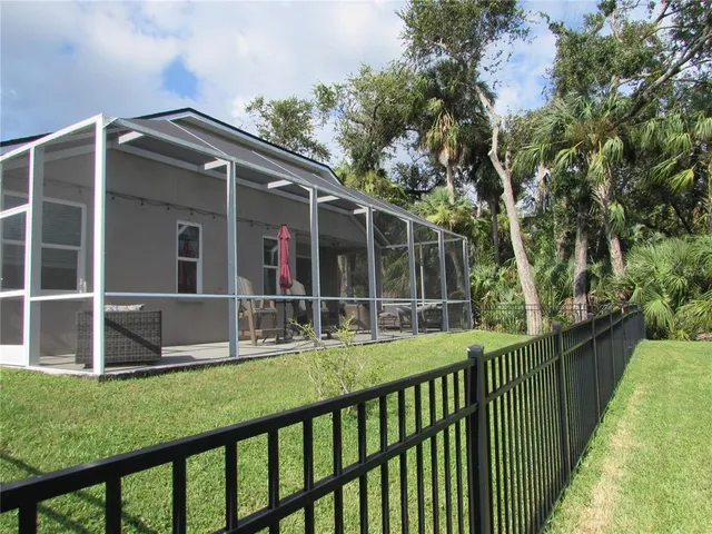 a view of house with a yard and staircase
