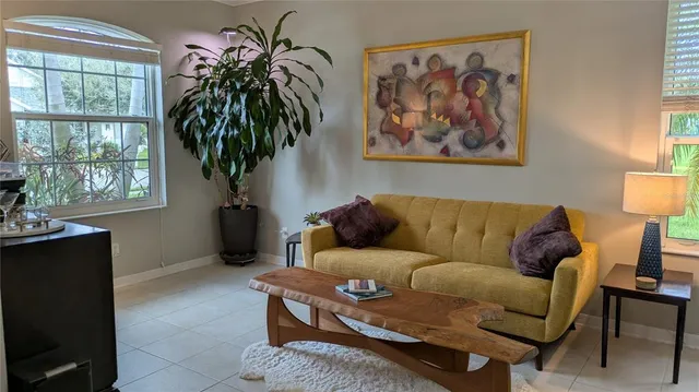 a living room with furniture and a potted plant