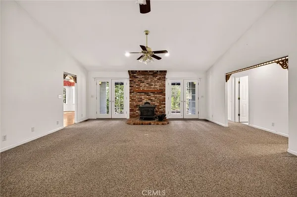 a view of an empty room with a fireplace