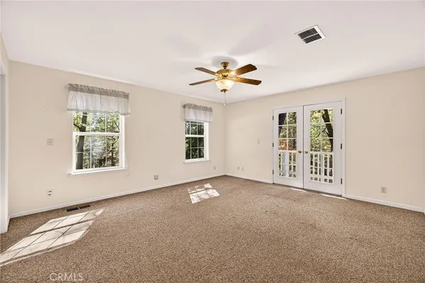 en house with a ceiling fan and a window