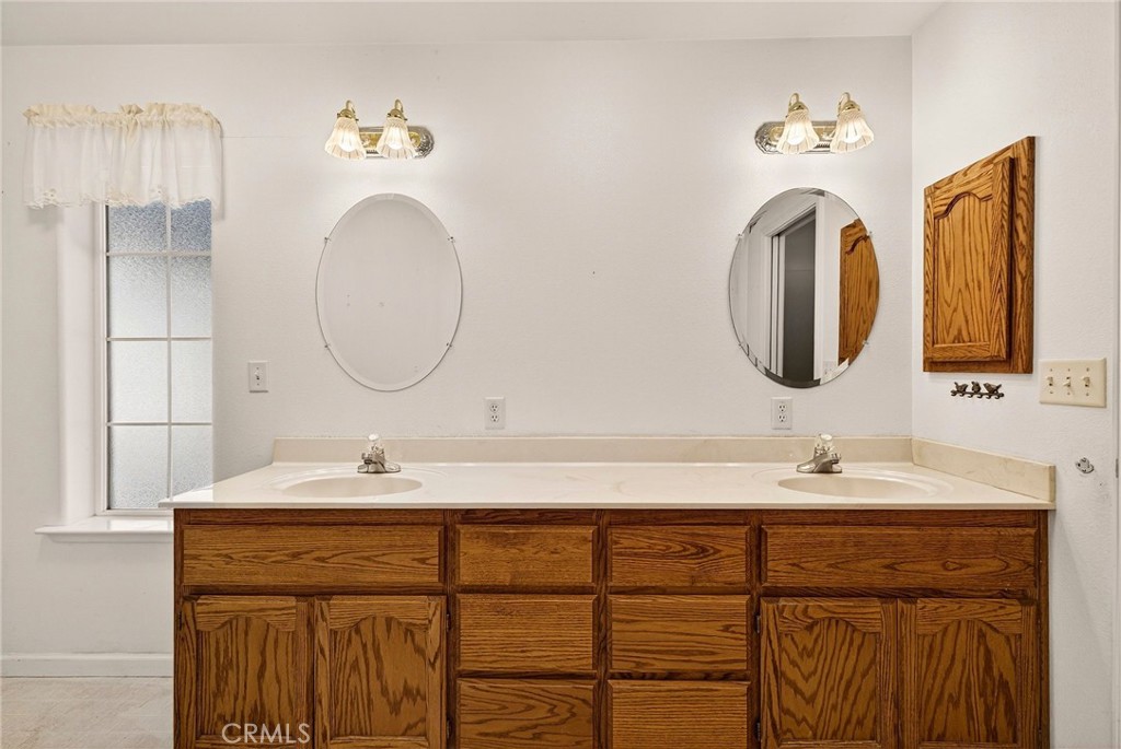 10202 Cohasset Road Chico, CA 95973 - Photo 29 of 75 a bathroom with a double vanity sink and a mirror