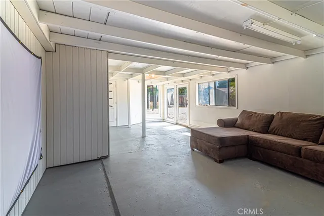 a front view of a house with a garden and patio
