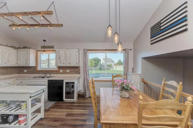 a living room with furniture a fireplace and a chandelier