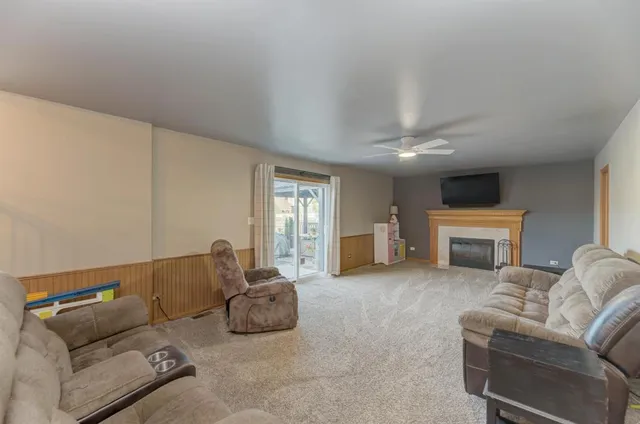 a living room with furniture a fireplace and a window