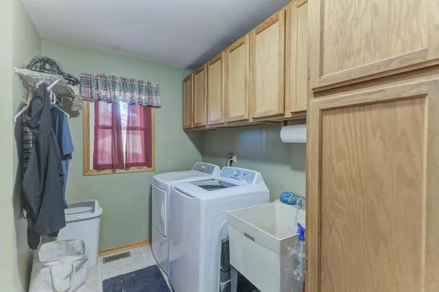 a bathroom with a sink a toilet and a window