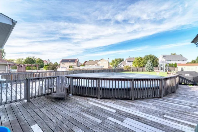 a view of a deck with wooden floor and fence