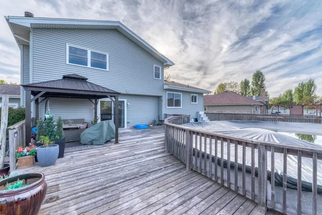 a view of a house with wooden deck and furniture