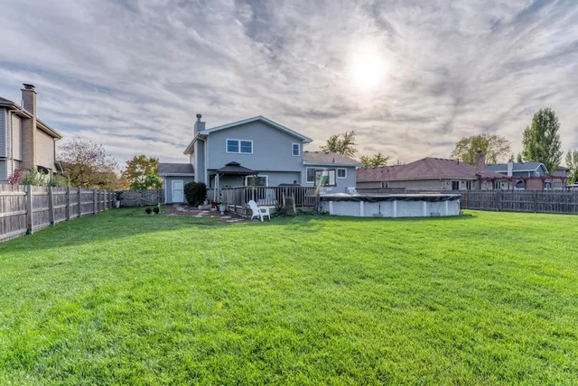a view of a house with a big yard and large trees