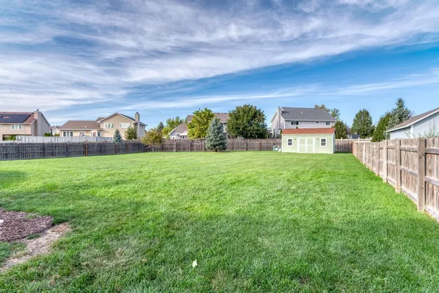 a view of a garden with a building in the background