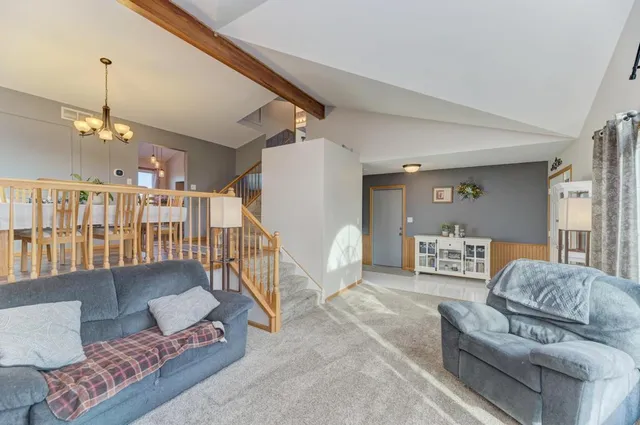 a living room with furniture and a chandelier