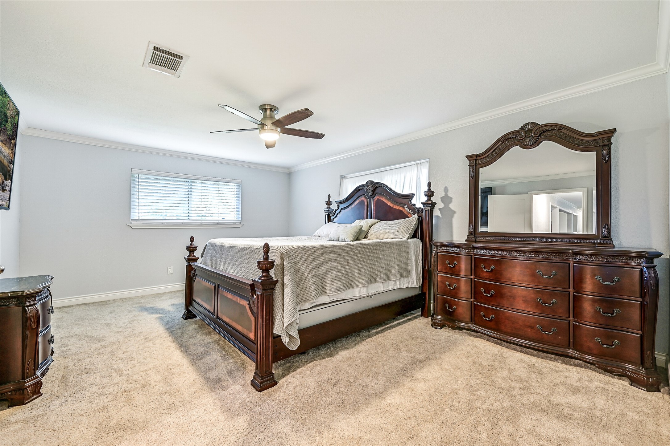 209 Buffalo Trail Lake Jackson, TX 77566 - Photo 19 of 34 a bedroom with a bed and a dresser