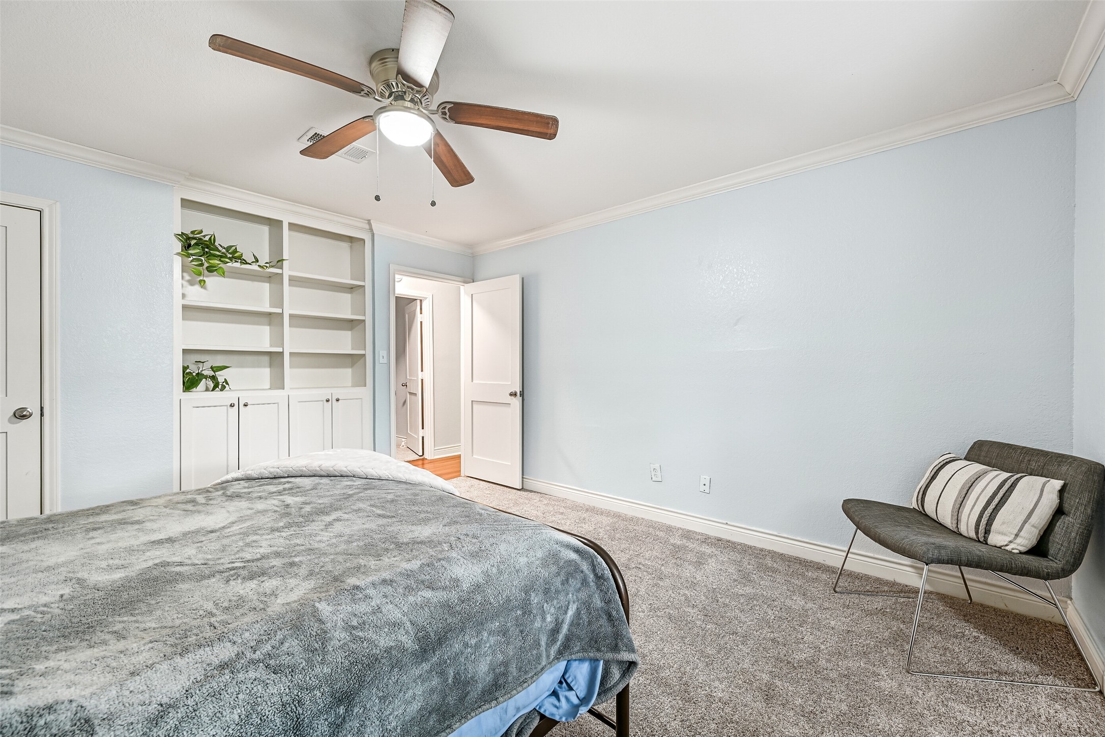 209 Buffalo Trail Lake Jackson, TX 77566 - Photo 24 of 34 a bedroom with a bed a chair and a large window