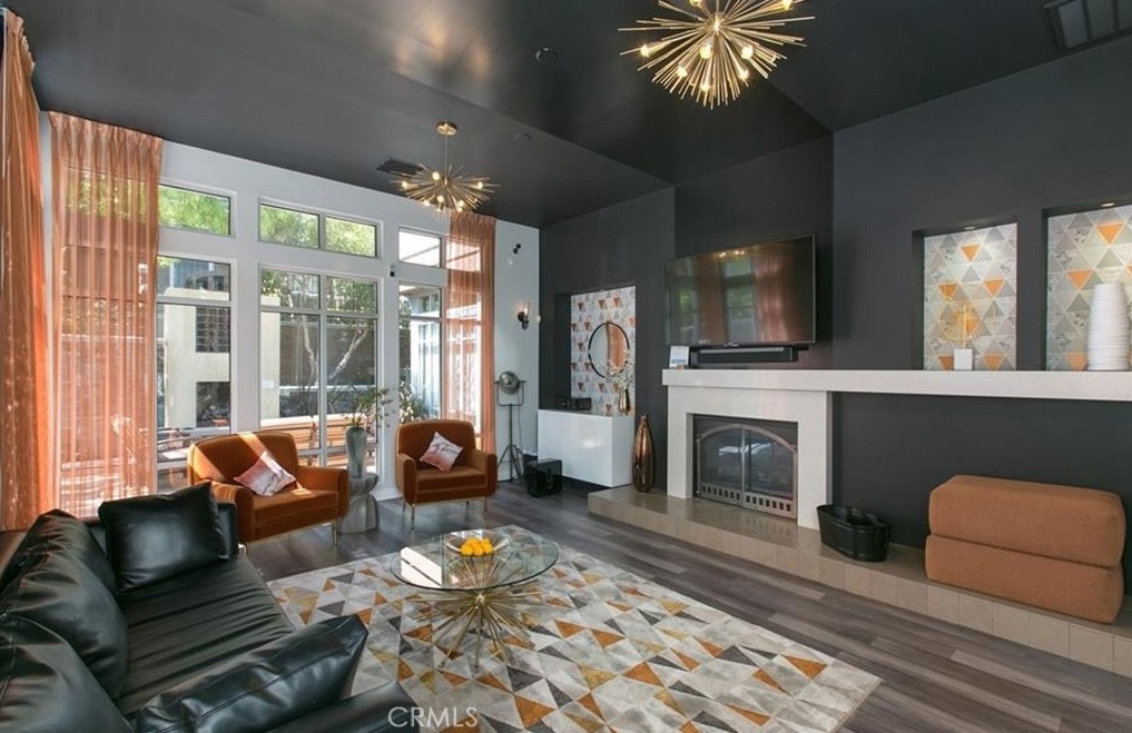 24 Colonial Way Aliso Viejo, CA 92656 - Photo 16 of 27 a living room with furniture a fireplace and a floor to ceiling window