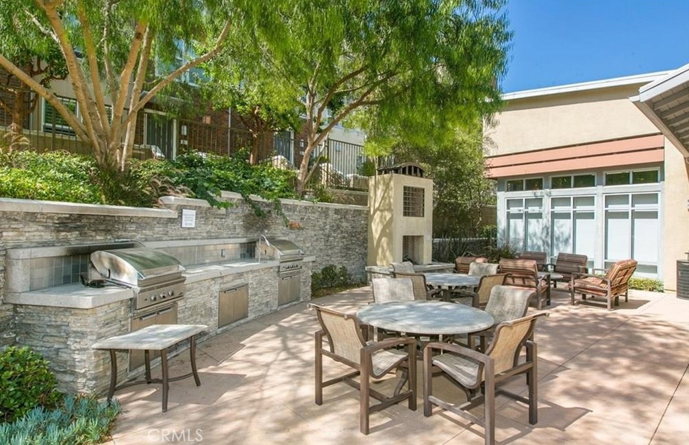 24 Colonial Way Aliso Viejo, CA 92656 - Photo 21 of 27 a view of a patio with table and chairs and potted plants