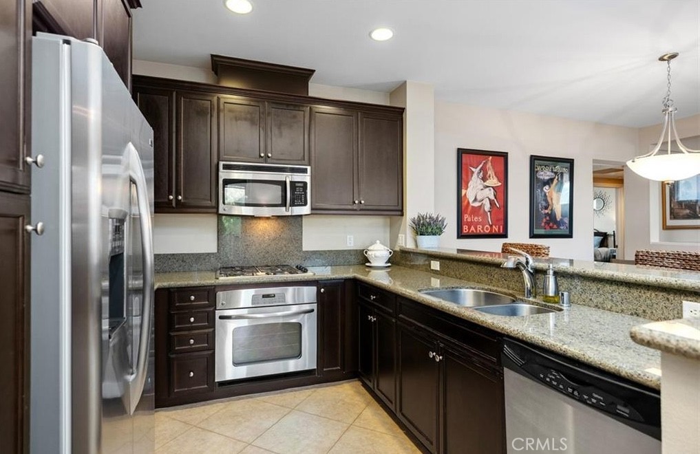 24 Colonial Way Aliso Viejo, CA 92656 - Photo 5 of 27 a kitchen with stainless steel appliances granite countertop a sink stove and refrigerator