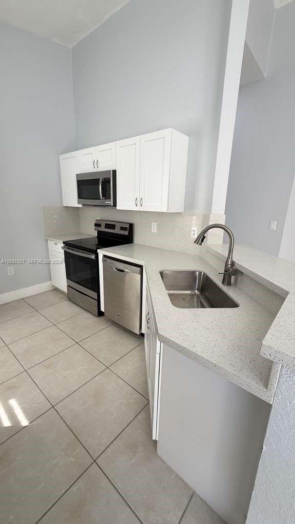 2120 Northeast 37th Road, Unit 1 Homestead, FL 33033 - Photo 18 of 30 a kitchen with a sink and steel appliances
