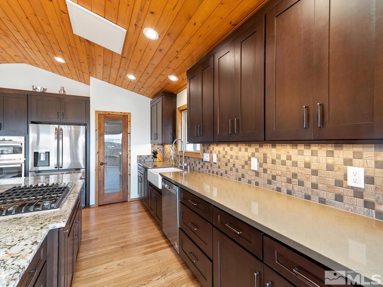 700 Saddleback Road Reno, NV 89521 - Photo 13 of 38 a kitchen with sink cabinets and stove