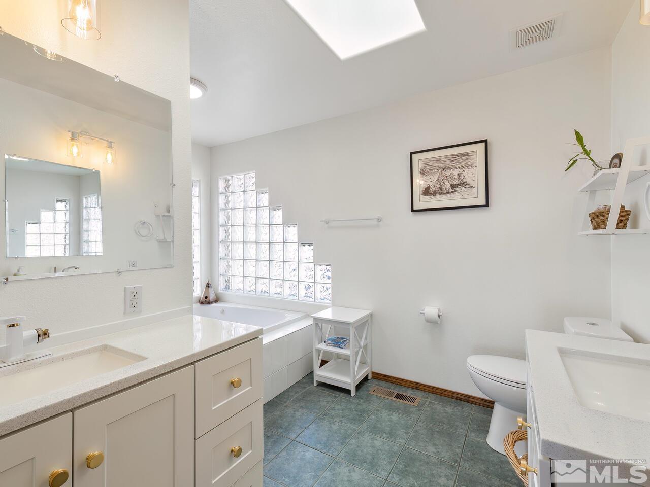 700 Saddleback Road Reno, NV 89521 - Photo 23 of 38 a spacious bathroom with a double vanity sink toilet mirror and bathtub
