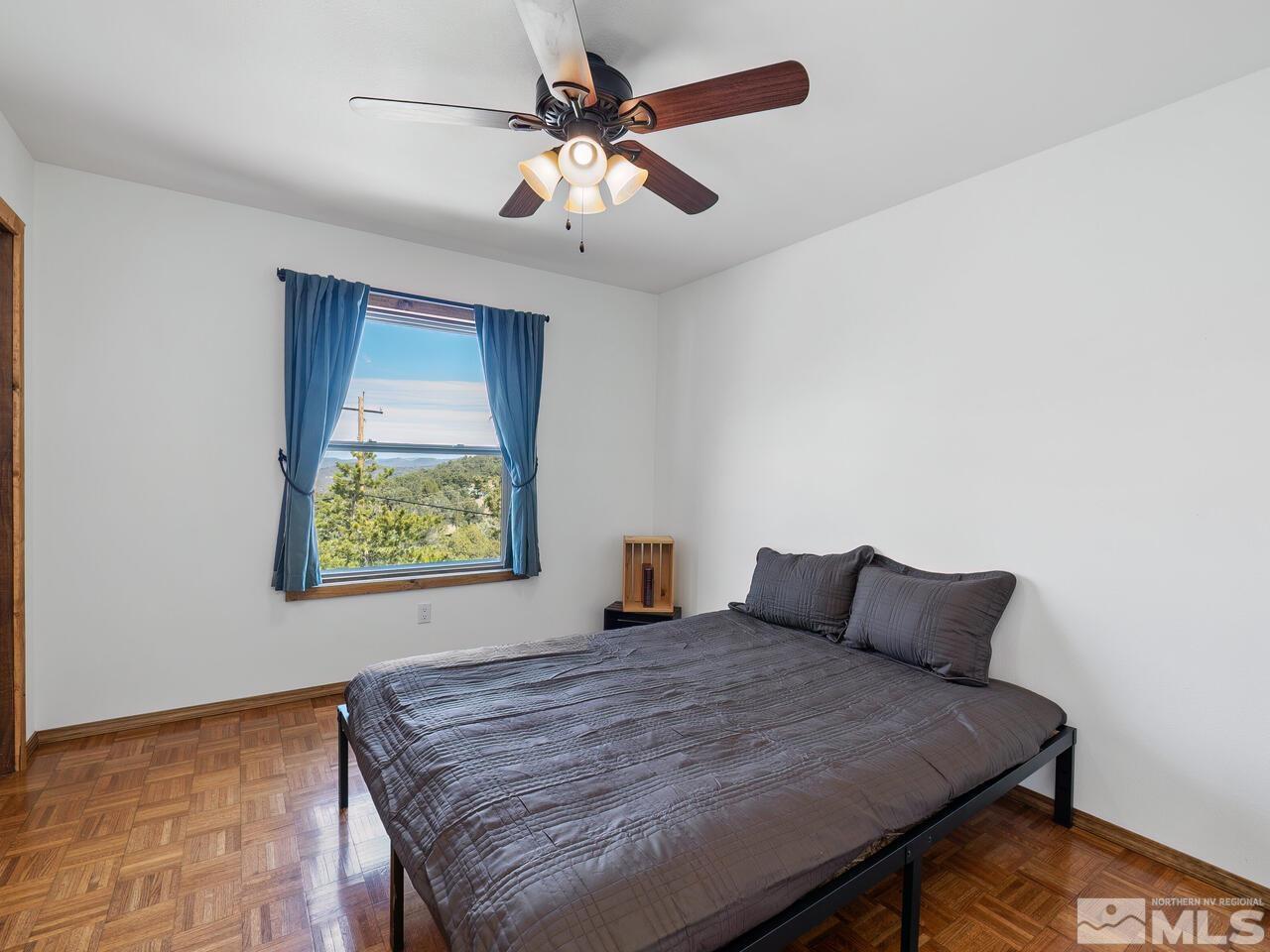 700 Saddleback Road Reno, NV 89521 - Photo 29 of 38 a bedroom with a bed and a chandelier