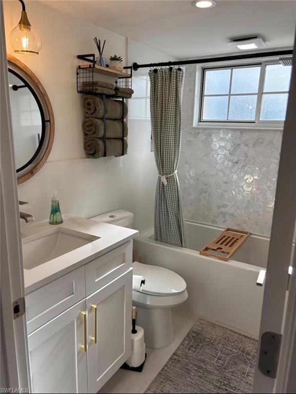 14993 Rivers Edge Court, Unit 246 Fort Myers, FL 33908 - Photo 9 of 23 a bathroom with a granite countertop toilet sink and mirror