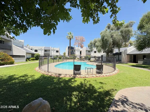 a view of a yard with swimming pool