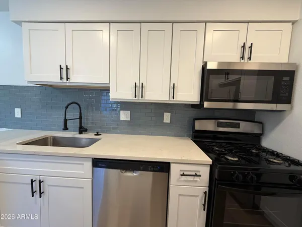 a kitchen with a sink and cabinets