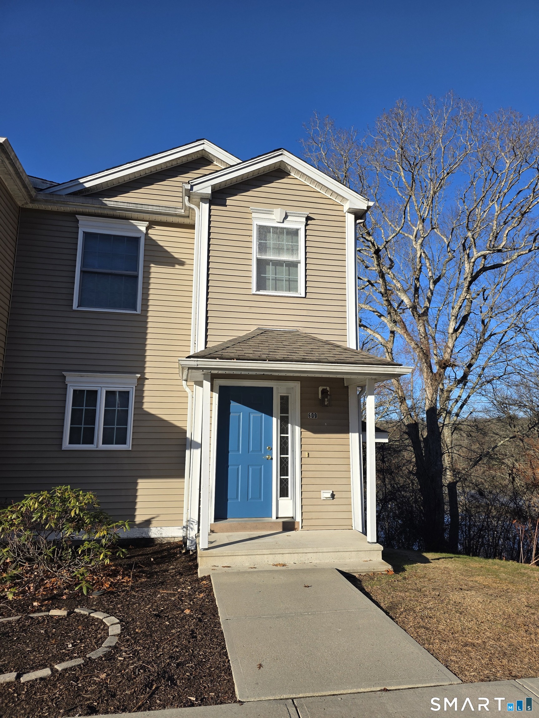 148 Mathewson Street, Unit 609 Griswold, CT 06351 - Photo 1 of 1 a front view of a house with a yard
