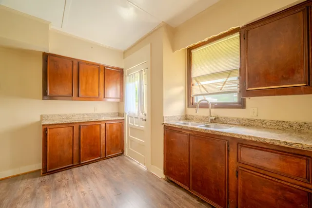 a kitchen with granite countertop a sink and cabinets