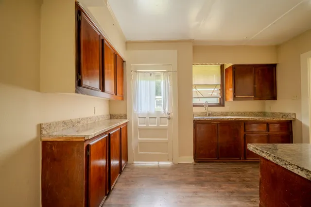 a kitchen with granite countertop cabinets stainless steel appliances a sink and a counter top space
