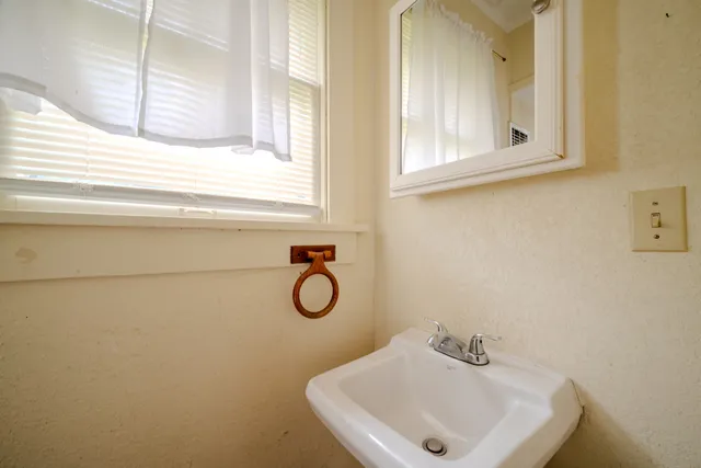 a bathroom with a sink and a window