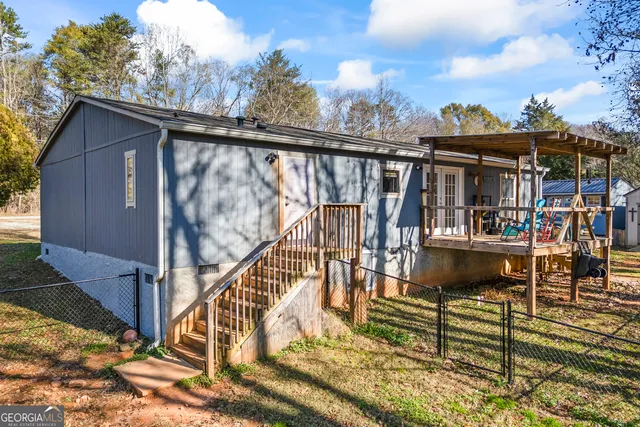 a view of a balcony with chairs and wooden floor